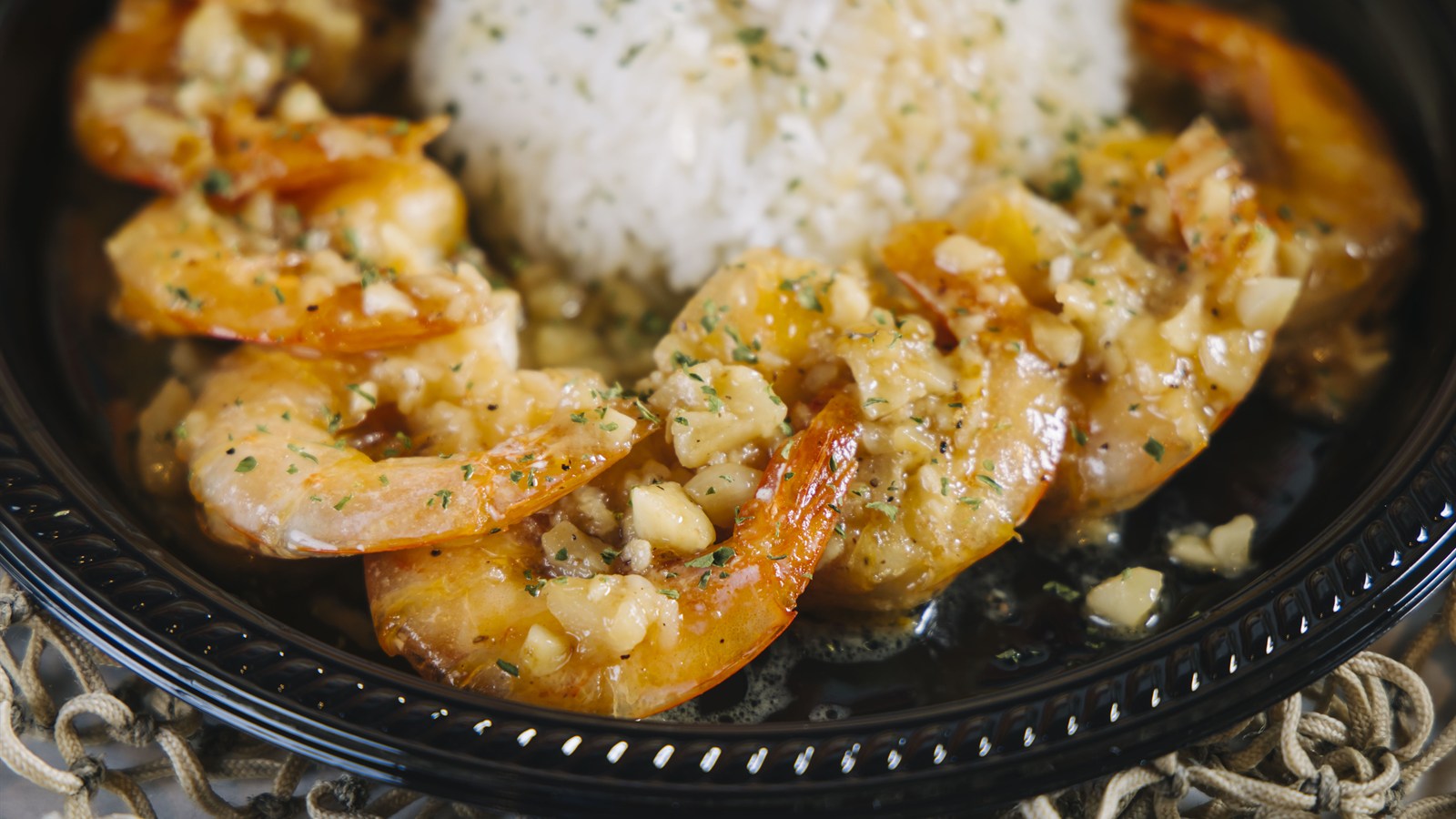 Garlic butter head-off shrimp served with rice at The Kickin' Crab